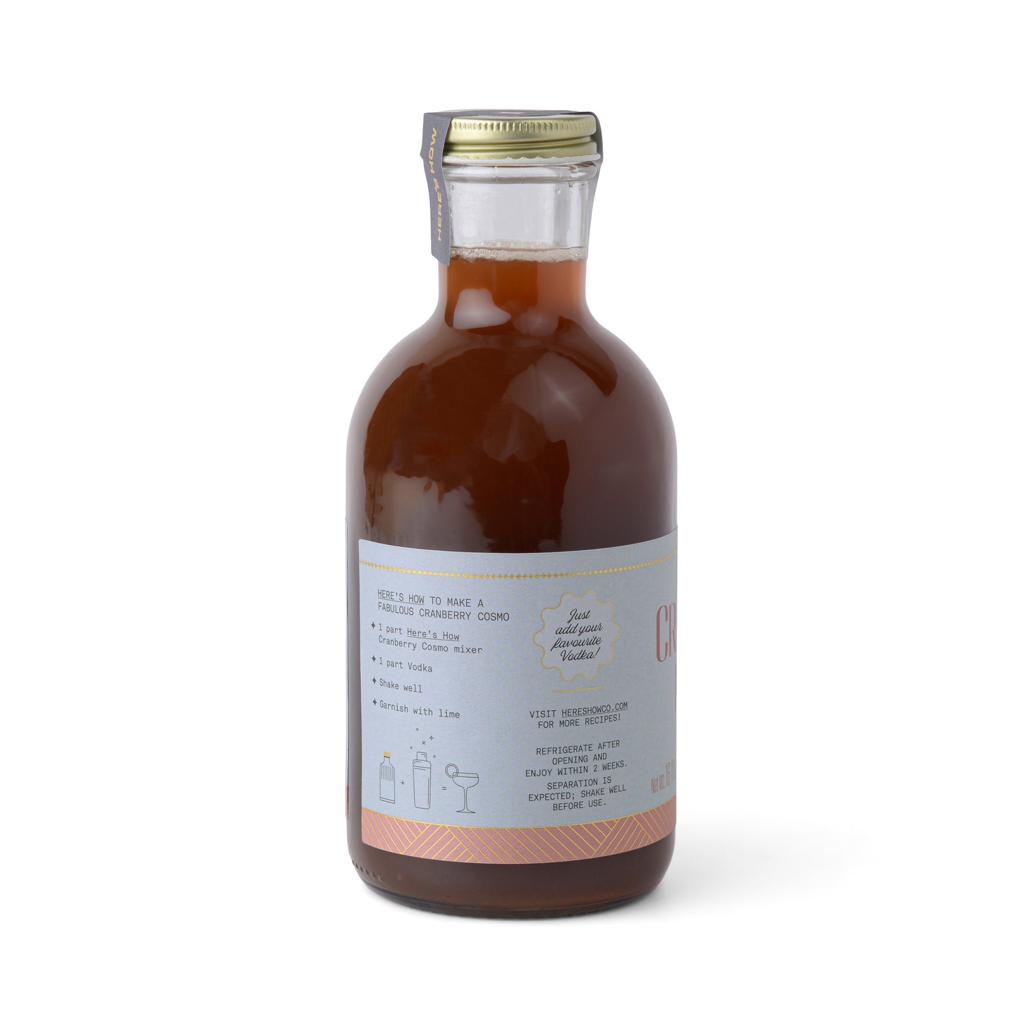 A glass bottle labeled with a Cranberry Cosmo recipe and product info holds reddish-brown liquid—ideal for crafting this festive cocktail at your next holiday party.