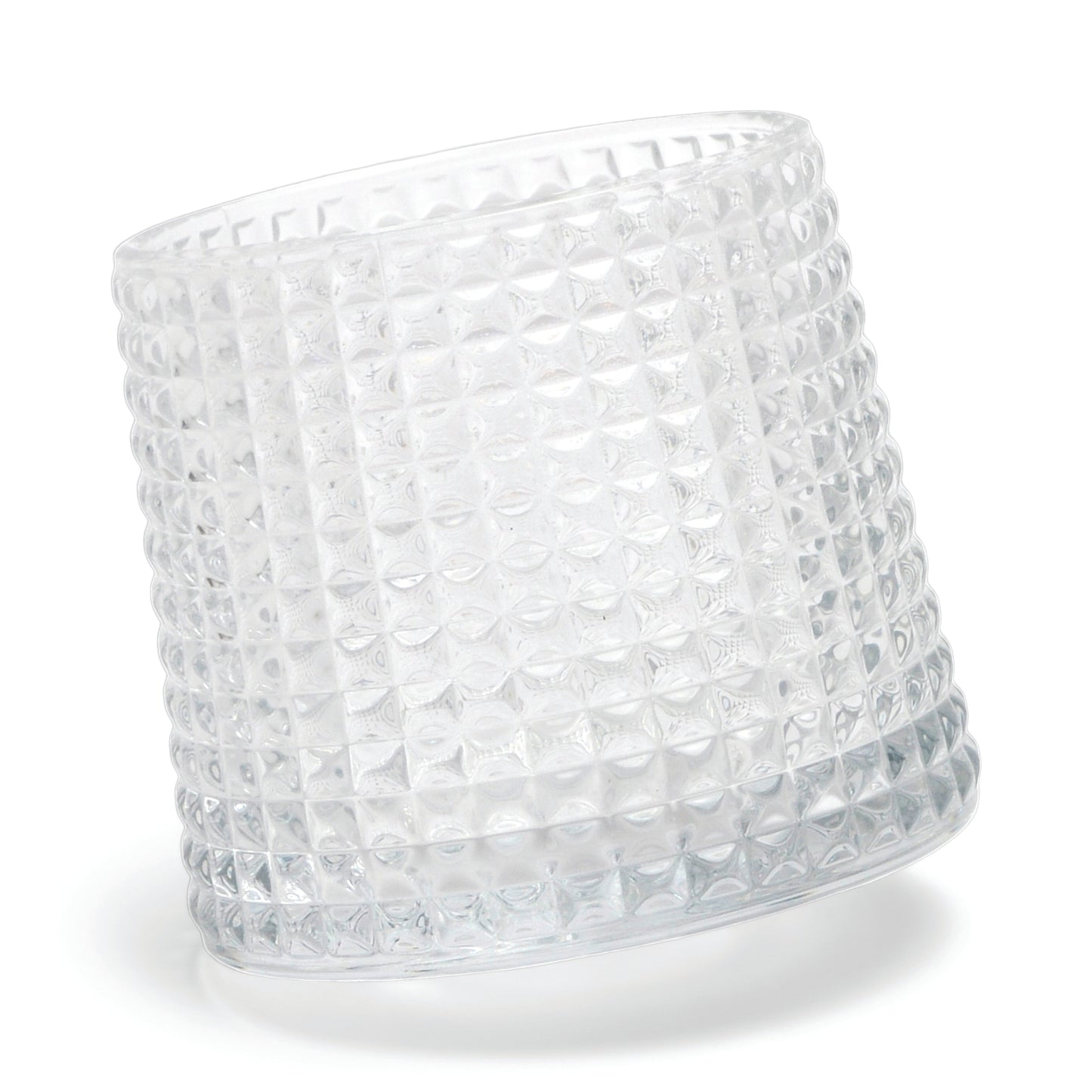 The Lola textured clear glass tumbler with a spherical bottom design lies on its side against a white background.