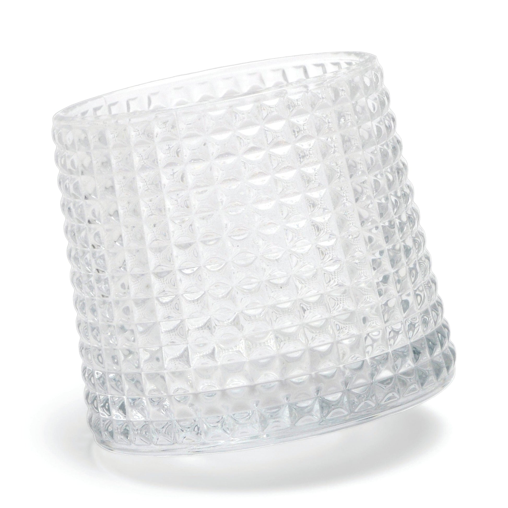 The Lola textured clear glass tumbler with a spherical bottom design lies on its side against a white background.