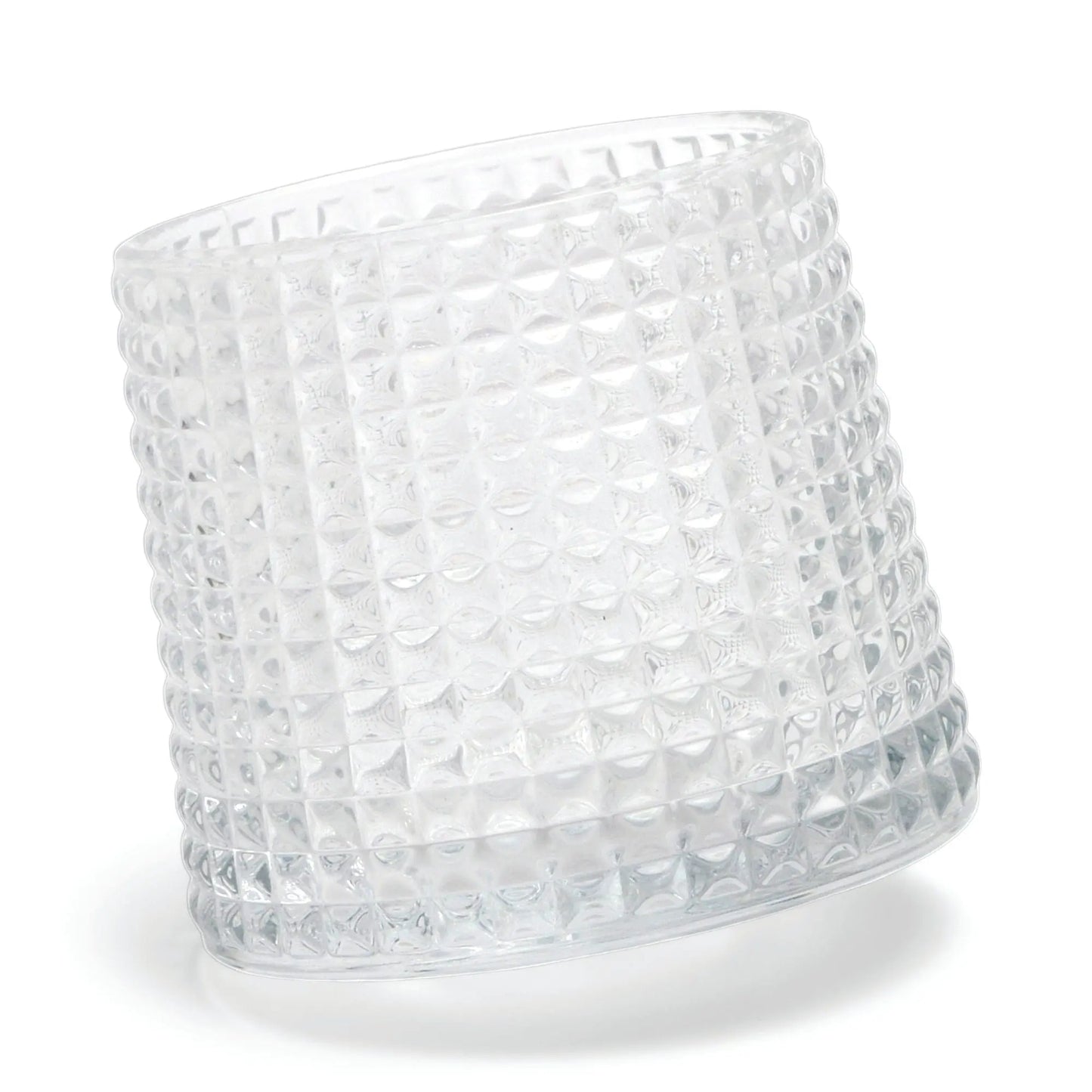 The Lola textured clear glass tumbler with a spherical bottom design lies on its side against a white background.