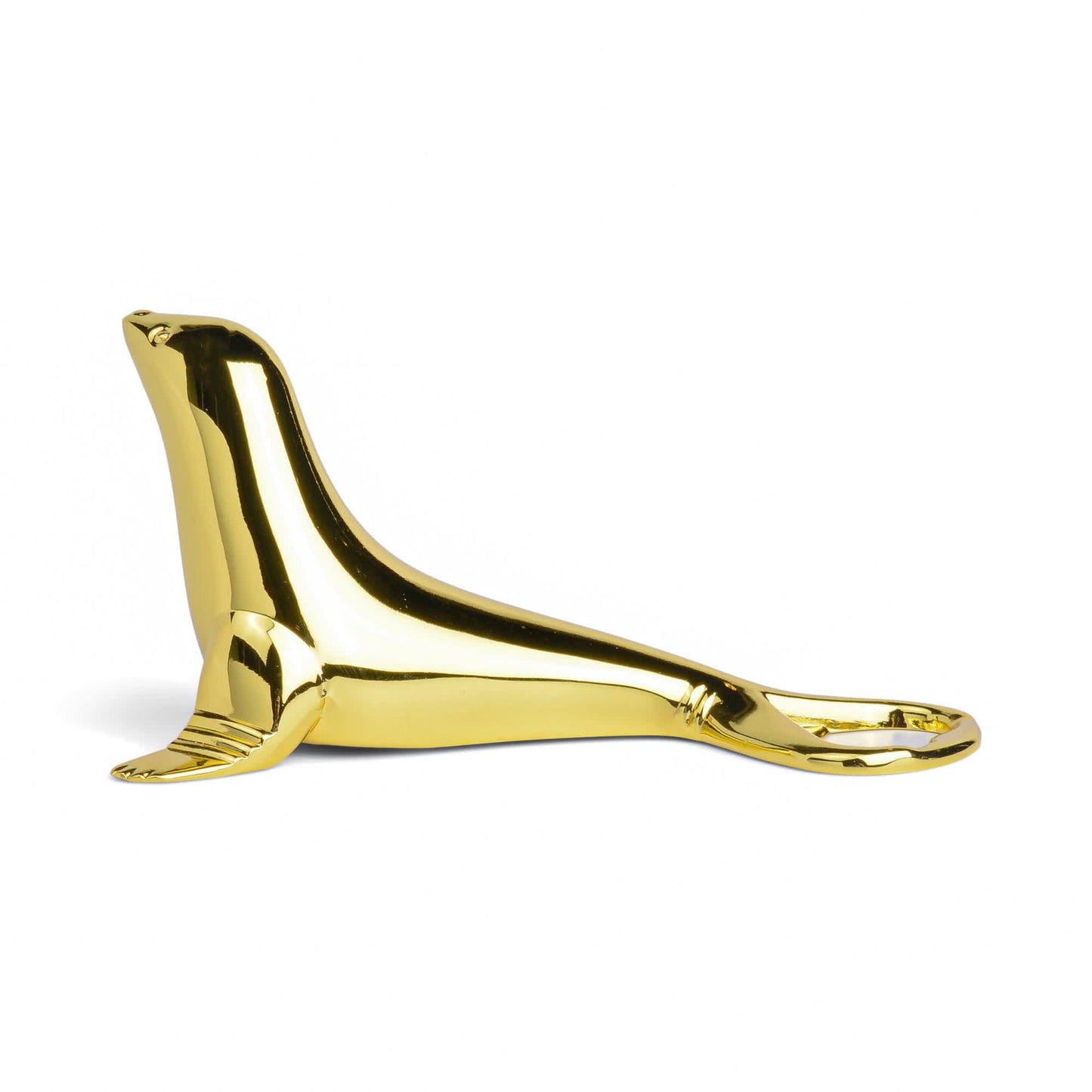 Elevate your entertaining with The Blu Seal Bottle Opener—a gold-colored opener shaped like a seal, its tail forming the functional end. Oceanside elegance for your essentials.