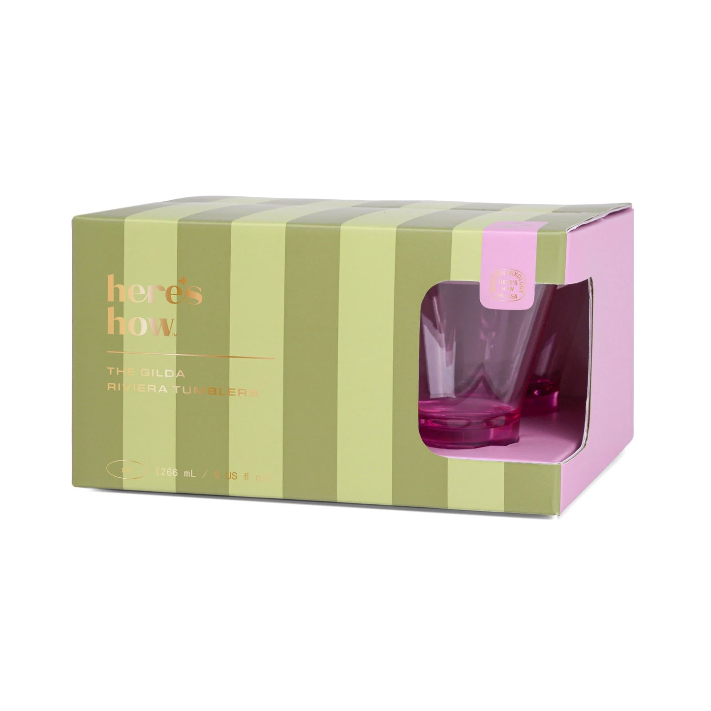 A green and pink striped box labeled heres how holds The Gilda Tumbler—a chic pink glass perfect for stylish beach cocktails.
