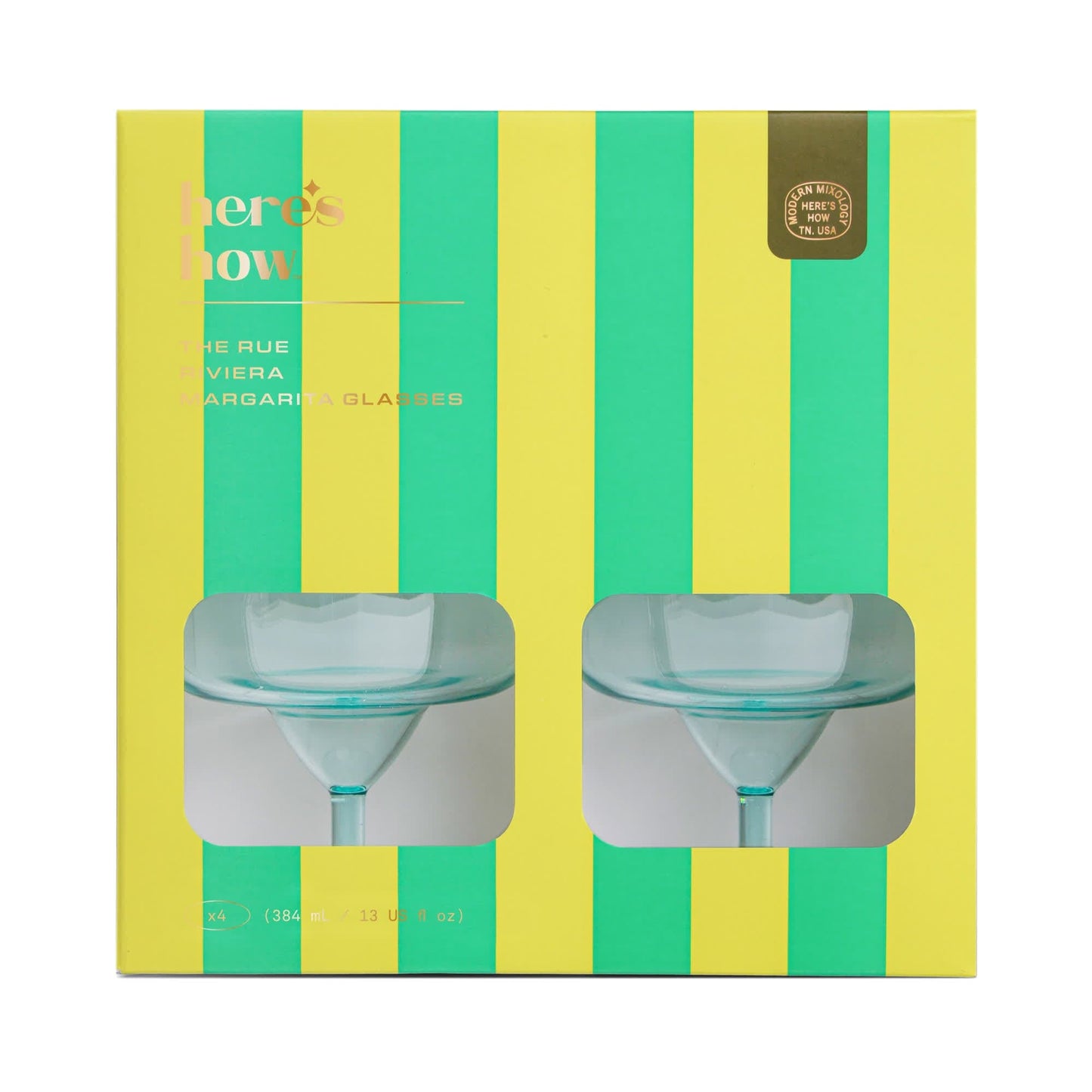 A yellow and green striped box with clear windows reveals two margarita glasses—ideal for sunny days or festive nights; labeled The Rue Margarita Glass.