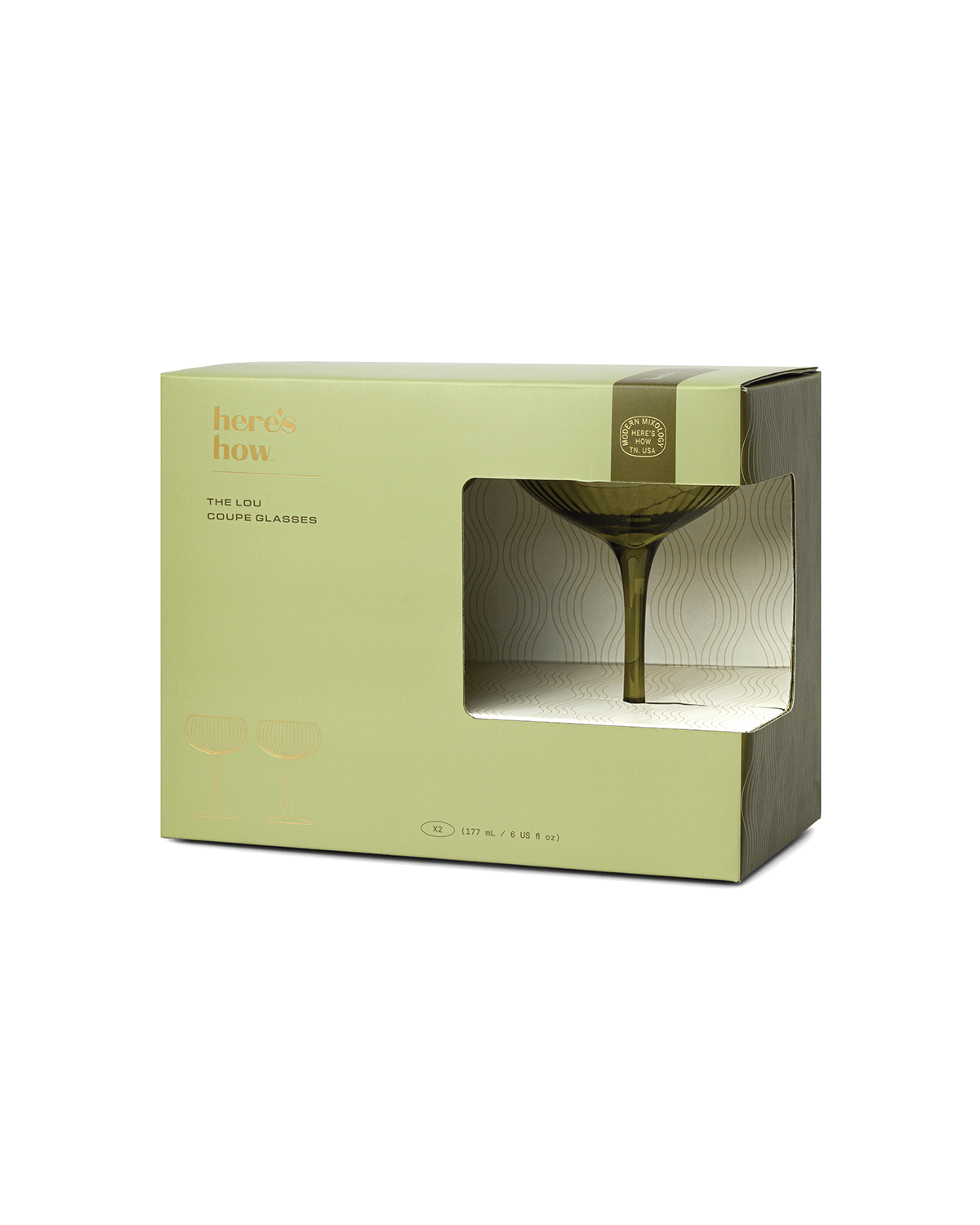 A green and beige box labeled heres how displays The Lou coupe glassware through a clear window, with text noting it contains two 210 ml glasses—perfect for serving your next craft cocktail in style.