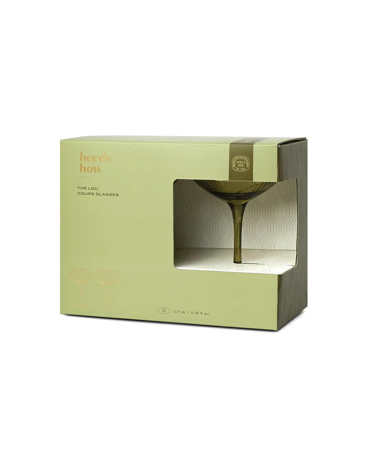 A green and beige box labeled heres how displays The Lou coupe glassware through a clear window, with text noting it contains two 210 ml glasses—perfect for serving your next craft cocktail in style.