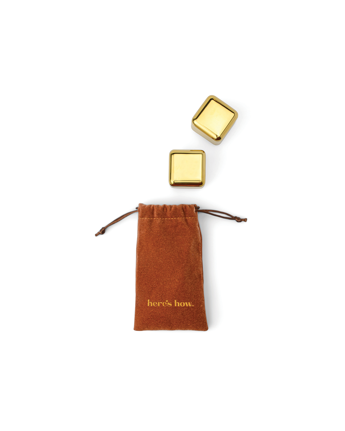 A brown drawstring pouch labeled heres how. sits below two The Jupiter stainless-steel cocktail chillers that keep drinks cold, all shown on a white background.