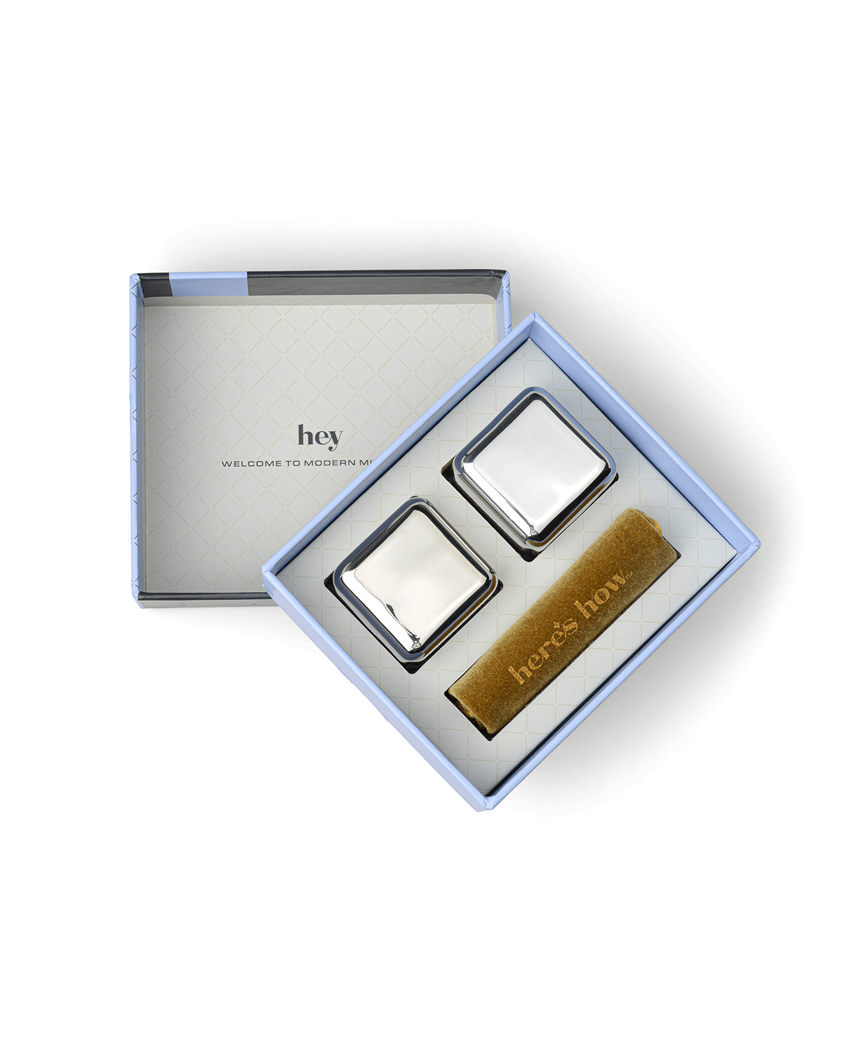 The Jupiter includes two stainless-steel cocktail chillers and a gold heres how card in an open gift box. The box reads hey WELCOME TO MODERN MIN—ideal for keeping drinks cold without dilution.