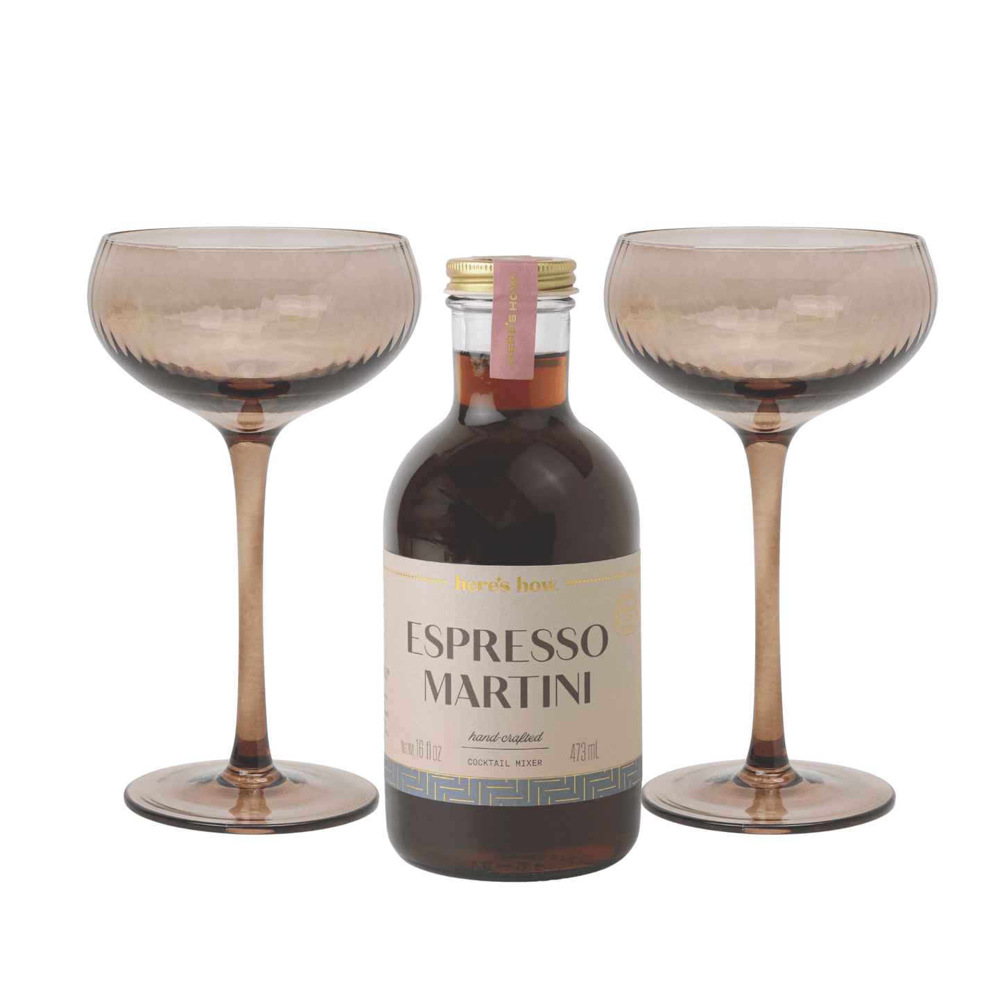 An Espresso Martini Kit sits between two empty, textured brown martini glasses on a white background—ideal for home bartenders seeking effortless sophistication.