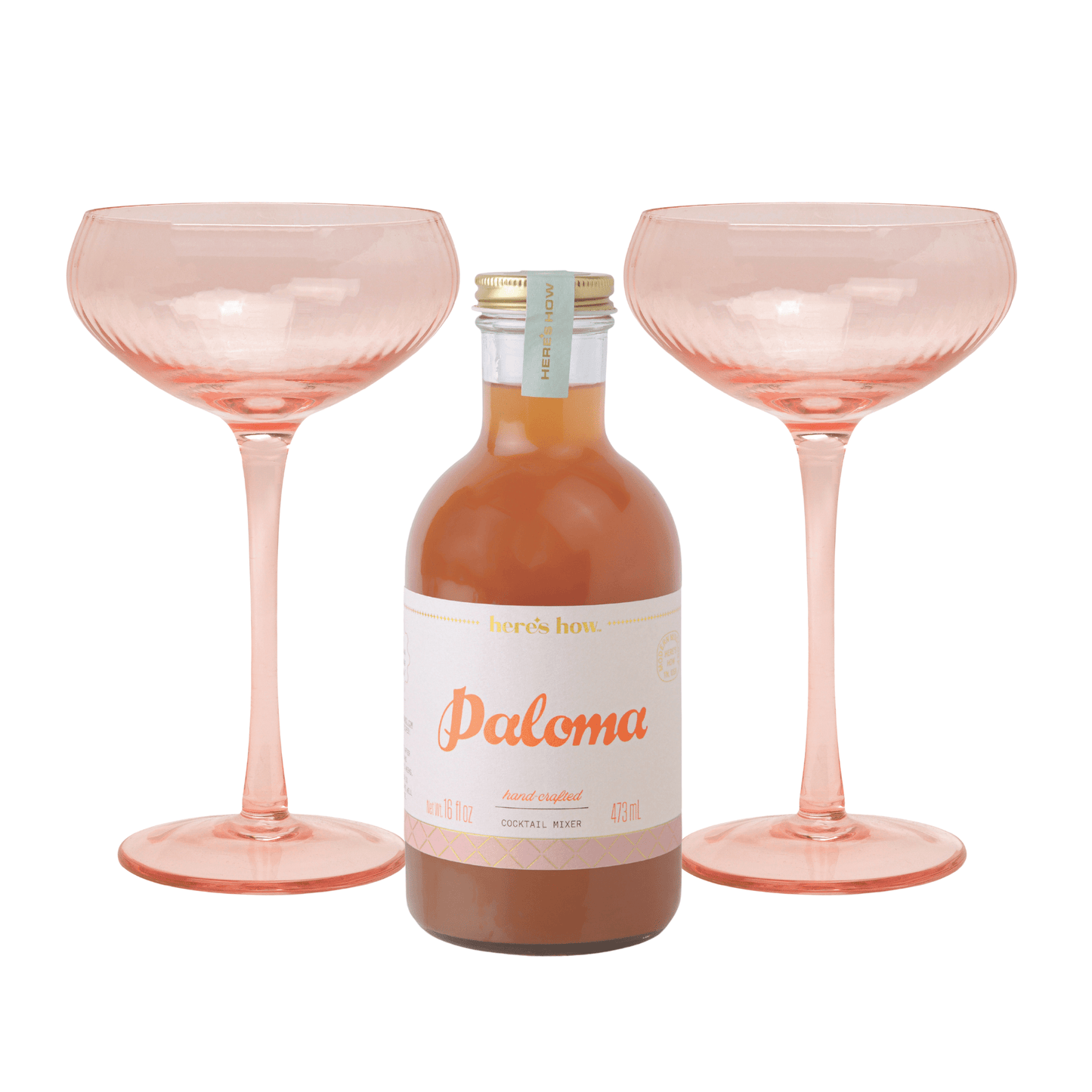The Paloma Kit is displayed between two empty Lou Coupe Glasses in a delicate blush hue, set against a white background.