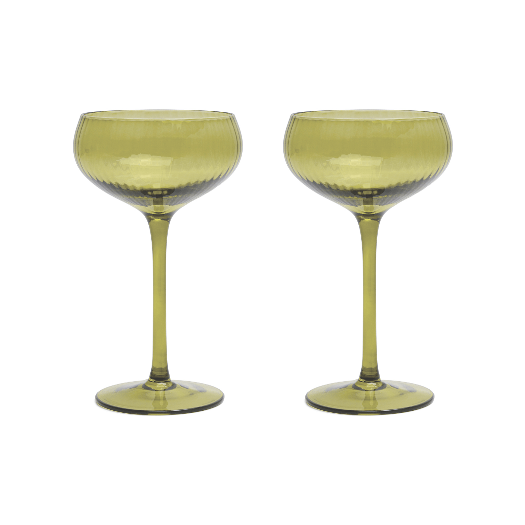 The Lou: Two green-tinted coupe glasses with textured bowls and long stems, displayed side by side on a white background, add vibrant mood-boosting color to any craft cocktail setting.