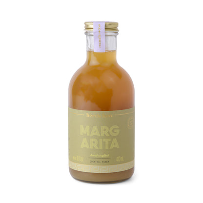 A clear glass bottle labeled Margarita with a gold and cream label, sealed cap, and containing 473 ml of orange-yellow cocktail mixer.