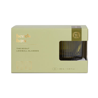 A green box labeled Heres How contains two The Scout Lowball Glasses, each 266 mL (9 fl oz), with a small window displaying the glassware inside.