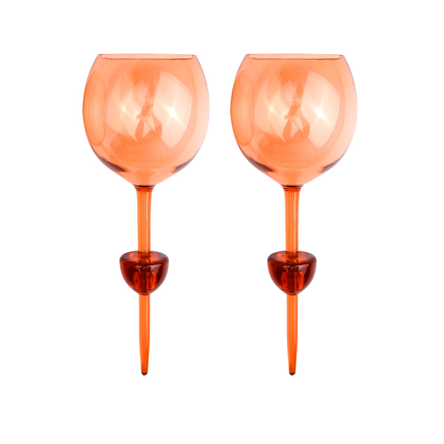 Two Bodie Riviera Glasses with orange-tinted, round bowls and thick stems stand side by side on a white background—ideal for outdoor enjoyment or stylish picnics.