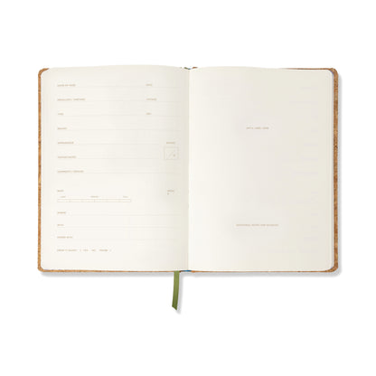 The Wine Journal - Cork Wine Bottle features an open spread with a cork-covered design, pre-printed fields on the left page for personal information, and a mostly blank right page ideal for tasting notes or additional observations. A green ribbon bookmark runs down the center.