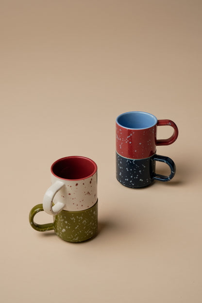 Two stacks of two speckled ceramic espresso mugs in The Simon Espresso Cups Set - Burgundy + Navy colors of burgundy, navy, olive, and cream for your coffee moment.