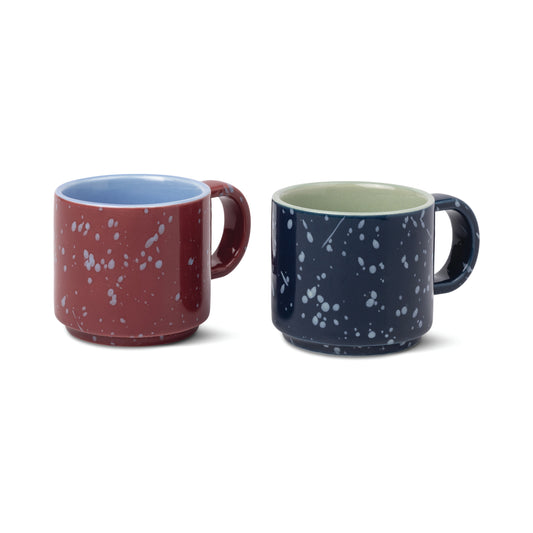 The Simon Espresso Cups Set - Burgundy + Navy features two speckled ceramic cups with light blue and pale green interiors for a cozy coffee moment.