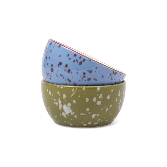 The Bella Ceramic Dipping Bowls - Blue + Olive Splatter, featuring two small, round, stacked bowls: one blue with dark speckles atop an olive green one with white speckles.