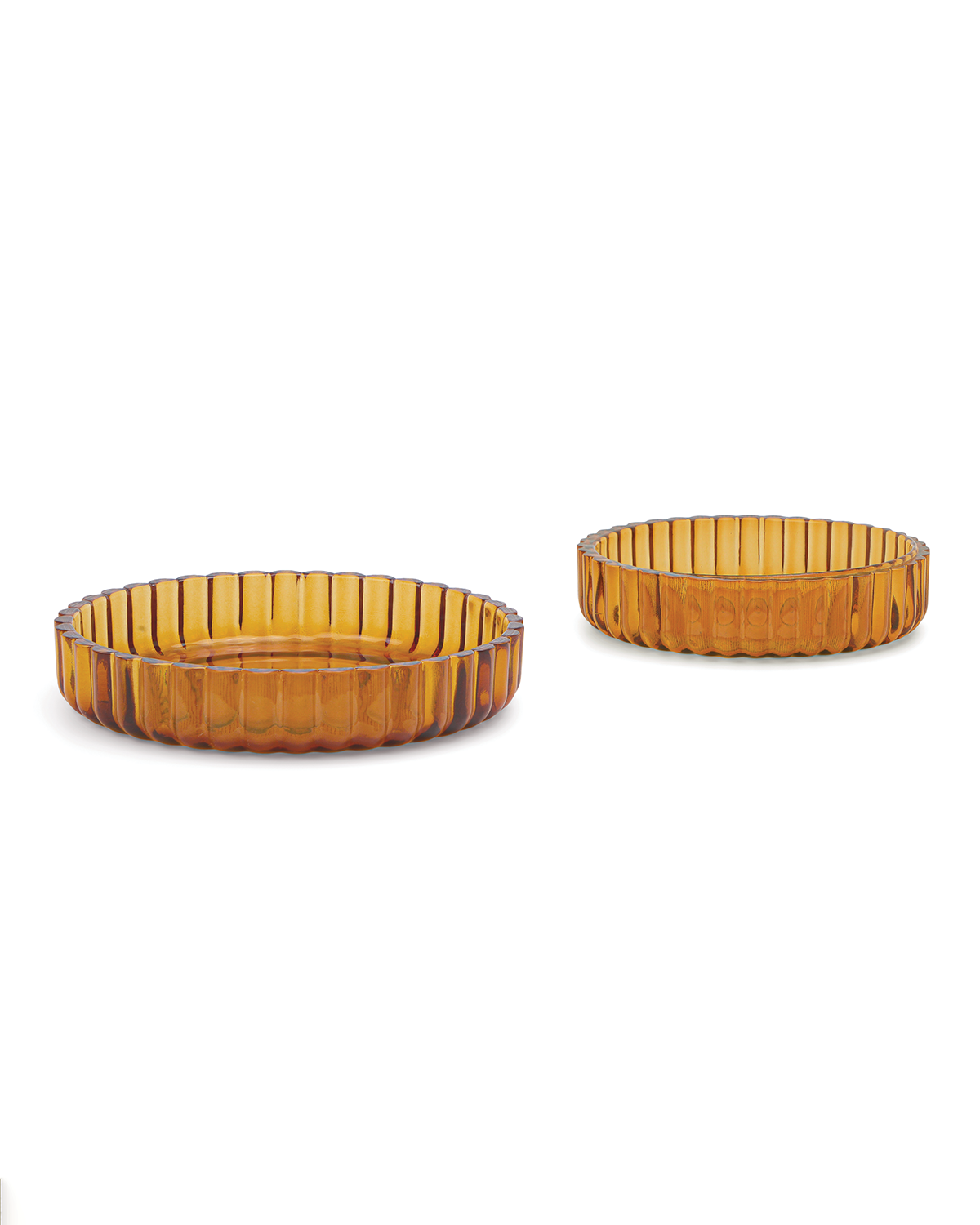 Mookie + Lenny: Two amber soda lime glass dishes with vertical ribbed patterns and round shapes, side by side on a white background—an elegant addition to your colored glass home bar essentials.