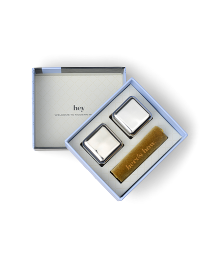 The Jupiter includes two stainless-steel cocktail chillers and a gold heres how card in an open gift box. The box reads hey WELCOME TO MODERN MIN—ideal for keeping drinks cold without dilution.