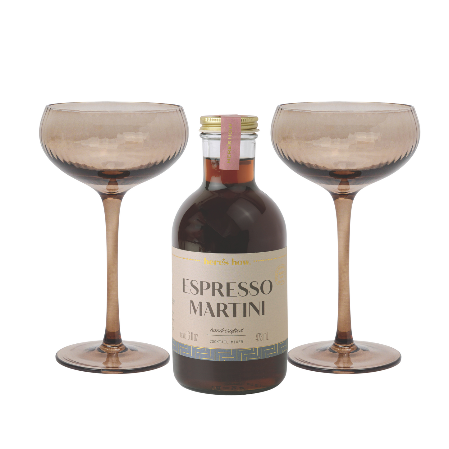 An Espresso Martini Kit sits between two empty, textured brown martini glasses on a white background—ideal for home bartenders seeking effortless sophistication.